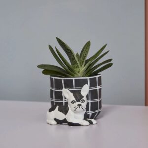 A black and white planter with a dog on it
