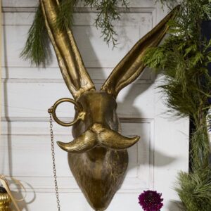A gold rabbit head with a mustache and ring on it's nose.