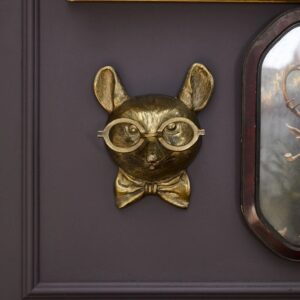 A door with a cat head and glasses on it.