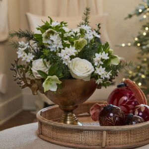A bowl of flowers on top of a table.