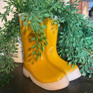 A pair of yellow boots sitting on top of a table.