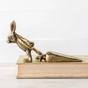 A bronze kangaroo bookmark on a book's edge.