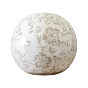 A white decorative ceramic sphere with intricate floral patterns.