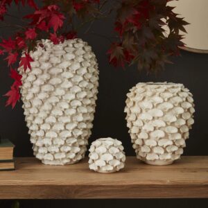 A set of three vases on top of a wooden table.