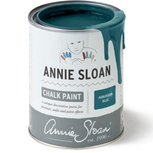 A can of Annie Sloan Chalk Paint with teal paint dripping down the side.